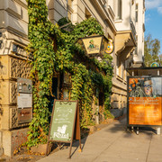 Noels Ballroom - Kneipen & Pubs in Leipzig Außenansicht des Noels Ballrooms und seine bewachsene Fassade, mit Schild und Straße im Hintergrund bei Sonnenschein
