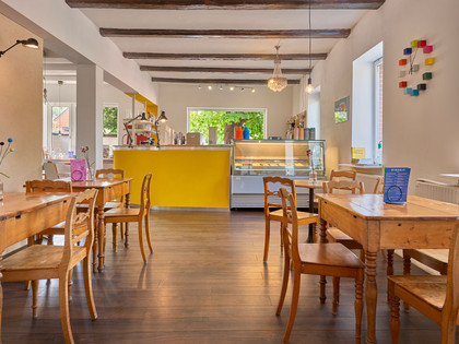 Eiszeit-Salzdahlum-Innen.jpg Innenraum mit Holztischen und Stühlen