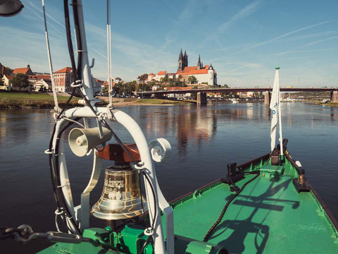 Ship on the Elbe near Albrechtsburg Meissen, bridge in the background in sunny weather.