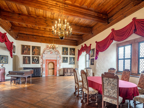 Ausstellungsraum Schloss Rochsburg - Schlösser der Leipzig Region Ein Ausstellungsraum des Museums mit Einrichtungsgegenständen wie Gemälden, Stühlen und Klavier aus der Zeit des 16. bis 19. Jahrhunderts auf Schloss Rochsburg in der Leipzig Region, Ausflugsziel