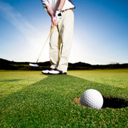 Golfer Sinking an Early Morning Putt Golfer Sinking an Early Morning Putt