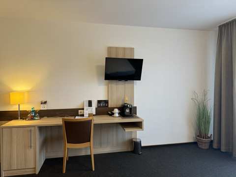 Hotel-Restaurant Zum Holländer - Ansicht Doppelzimmer 2 Zimmeransicht mit Schreibtisch, Stuhl, Fernseher und Kaffeemaschine an der Wand. Rechte Atmosphäre.