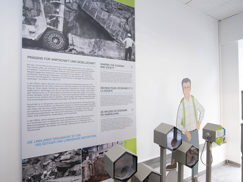 Bergisches Grauwacke-Museum Ausstellung über Steinindustrie mit Infotafeln, Schwarz-Weiß-Fotos und interaktiven Elementen.