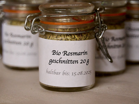 Hofladen-Sortiment im Spindlerhof Mehrere kleine verschlossene Gläser mit Rosmarin.