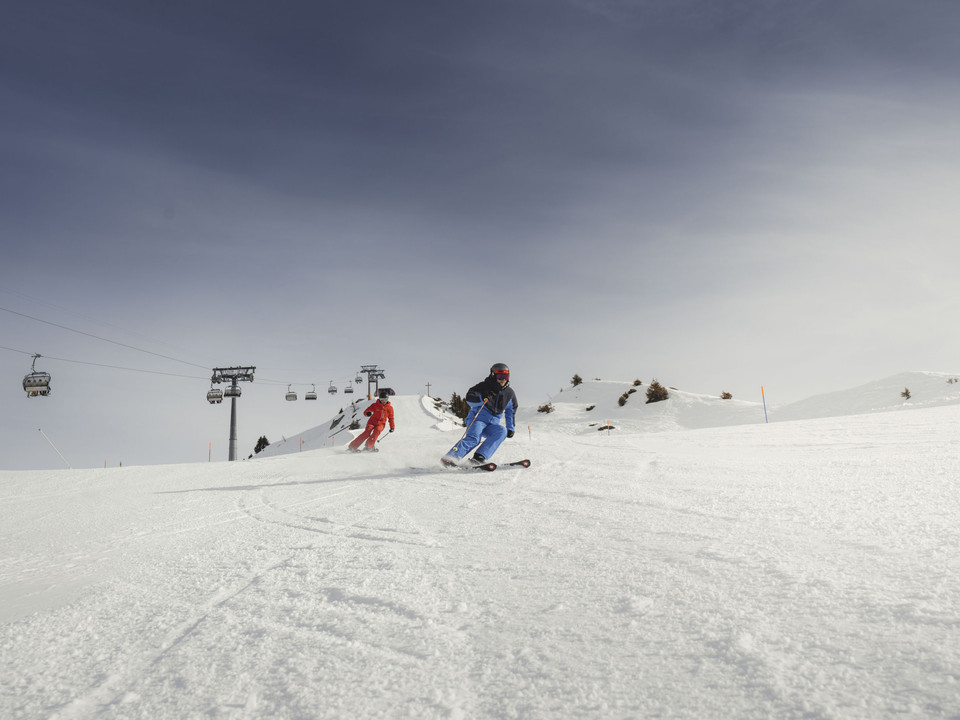Le ski sportif dans l'Aletsch Arena Zwei Skifahrer carven über die Piste im Sonnenschein während der Glacier Challenge Skiline Aletsch ArenaTwo skiers carve across the piste in the sunshine during the Glacier Challenge Skiline Aletsch ArenaDeux skieurs dévalent la piste sous le soleil pendant le Glacier Challenge Skiline Aletsch Arena