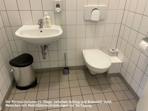 Staff toilet.jpg Bathroom, white tiled with washbasin, waste garbage can and toilet
