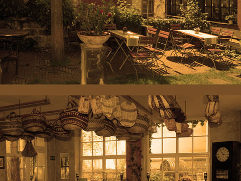 Inviting courtyard garden with wooden tables and a rustically decorated café interior.