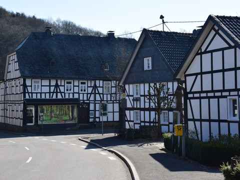 Fachwerkdorf Holpe <p>Fachwerkhäuser in Morsbach an einer ruhigen Straße mit Bäumen im Hintergrund.</p>