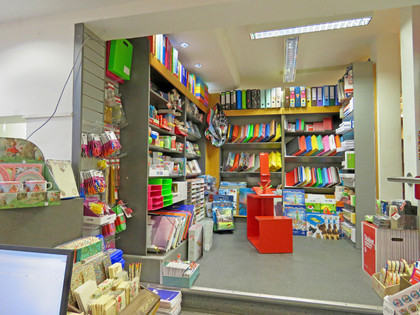 Steuber-innen.jpg Regale mit bunten Mappen und Heften