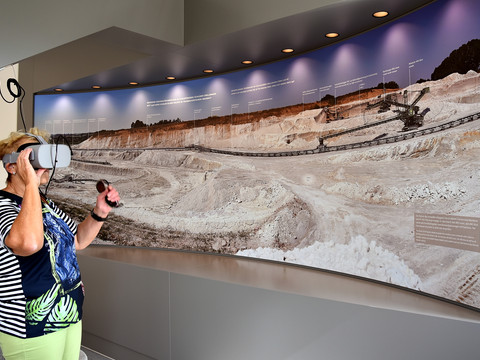 Virtual Reality im Geoportal Bahnhof Mügeln - Erlebnisausstellung in der Leipzig Region Eine Frau trägt eine Virtual Reality Brille im Geoportal Bahnhof Mügeln in der Erlebniswelt Kaolin, Ausflug, Ausstellung, Familie