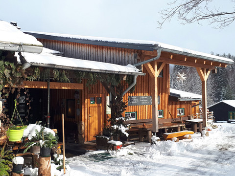 Ottendorfer Hütte im Winter Ottendorfer Hütte im verschneiten Winterwald mit Holzhütte und einladender Veranda.