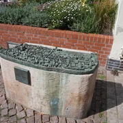 Stadtmodell Verden Detailliertes Bronzemodell der Altstadt Verden auf einem Steinsockel, umgeben von Blumenbeet.