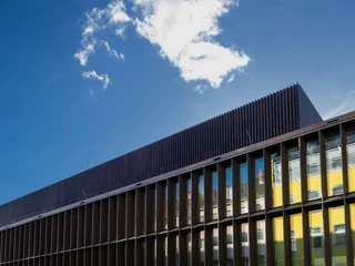 Historical Archive of the City of Cologne with Rhenish Image Archive Modernes Gebäude mit blauen Spiegelglas-Fenstern unter klarem Himmel mit vereinzelten Wolken.Modern building with blue mirror glass windows under a clear sky with scattered clouds.