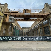 Pittlerwerke Leipzig - DIMENSIONS - Digital Art ● since 1859 Fassade der ehemaligen Werkshallen der Pittlerwerke Leipzig mit Werbebanner zur Ausstellung DIMENSIONS - Digital Art sind 1859
