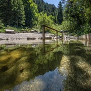 Kneippbecken Farchant Kuhfluchtwasser im Vordergrund mit Stange zum Einhalten, im Hintergrund Bänke