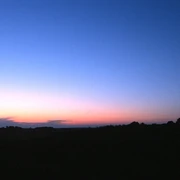 EXPO-Sternwarte Einsame Mühle im Abendlicht vor einem eindrucksvollen Sonnenuntergangshimmel.