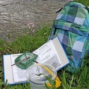 Wasserforscherrucksack neben dem Bach