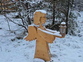 The wooden angel lights the way with his lantern