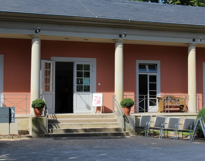 Tourist-Info Romantik Bad Rehburg Tourist-Information in Bad Rehburg mit offener Eingangstür und Stufen, umgeben von Säulen.