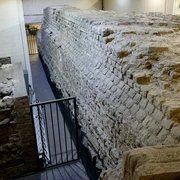 Roman city wall Die Aufnahme zeigt einen Abschnitt der antiken römischen Stadtmauer in Köln, eindrucksvoll eingebettet in eine moderne Tiefgarage. The photo shows a section of the ancient Roman city wall in Cologne, impressively embedded in a modern underground parking garage.