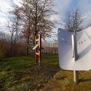Sonnige Zeiten Sonnenuhr in herbstlicher Parklandschaft mit kahlen Bäumen und bewölktem Himmel fotografiert.