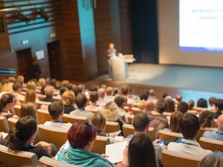 Business speaker giving a talk in conference hall. Business-Redner hält einen Vortrag in einem Konferenzsaal.Business speaker giving a talk in conference hall.