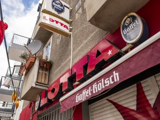 Lotta Bar Blick auf die Außenfassade und auf das Barschild. View of the exterior façade and the bar sign.
