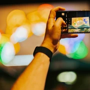 Supporting programme "Löffelfamilie" at Feinkost for your meeting & conference in Leipzig  Rahmenprogramm Blick druch Handykamera auf die beleuchtete Reklame Löffelfamilie auf dem Gelände der Feinkost für Tagung & Konferenz Leipzig ConventionSupporting programme View through cell phone camera of the "Löffelfamilie" neon sign at the area of Feinkost for meeting & conference Leipzig convention