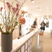 Hanssen by Herr Lutz Innenraum eines Optikergeschäfts mit Blumenstrauß im Vordergrund