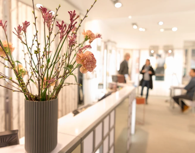 Hanssen by Herr Lutz Innenraum eines Optikergeschäfts mit Blumenstrauß im Vordergrund