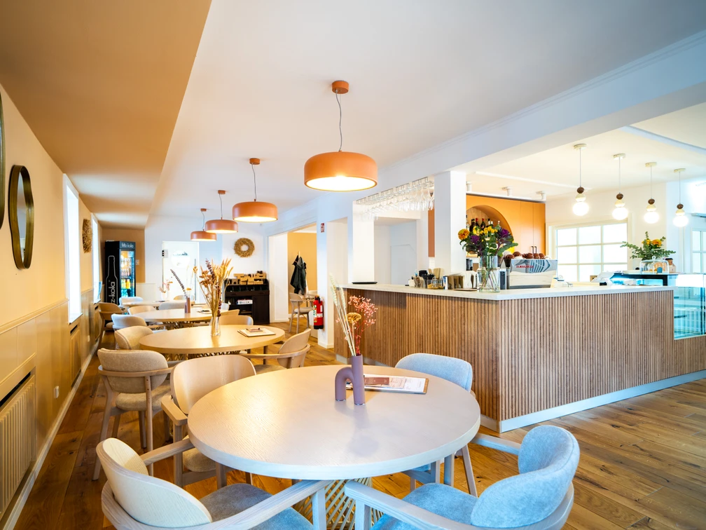 Nahé Café in Monheim am Rhein Modernes Café in Monheim am Rhein, mit stilvollen Holzmöbeln, warmem Licht und einladendem Ambiente.