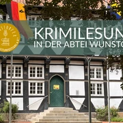 Wunstorfer Lese & Kulturfestival  Eingang zur Abtei Wunstorf mit stolzen Fahnen, Treppenaufgang und Veranstaltungsbanner.