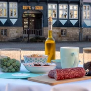 Genusspfade Gedeckter Tisch mit Leckereien zum Probieren auf dem sonnigen Stadtmarkt.