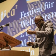 Fiston Mwanza Mujila at the Poetica Emotionaler Vortrag eines Gedichts auf der Bühne im Rahmen der Poetica.Emotional performance of a poem on stage as part of Poetica.