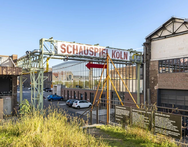 Schauspiel Ehemalige Industriehalle in Köln, jetzt das Schauspiel Köln, mit markanten Stahlträgern und Backsteinfassade.Former industrial hall in Cologne, now the Schauspiel Köln, with striking steel girders and brick façade.