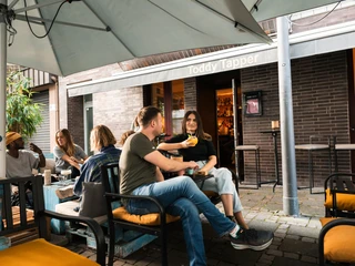 Toddy Tapper Das Toddy Tapper in Köln mit entspannter Atmosphäre, Menschen genießen Getränke im Außenbereich.The Toddy Tapper in Cologne with a relaxed atmosphere, people enjoying drinks in the outdoor area.