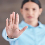 Stop, hand sign and woman with no gesture for sexual harassment and violence in workplace. Business professional, palm and female employee at company with stopping emoji for gender rights at job Stop, hand sign and woman with no gesture for sexual harassment and violence in workplace. Business professional, palm and female employee at company with stopping emoji for gender rights at job