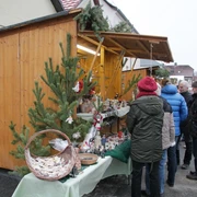 Weihnachtsmarkt Beucha - Weihnachten in der Region Leipzig Festlich geschmückter Weihnachtsmarktstand mit handgefertigten Waren, vor dem sich Besucher umschauen und stöbern