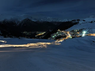 Night shot Bettmeralp with light trail Lichterspuren auf der Skipiste bei der Bettmeralp im Winter während des Mondscheinessen Aletsch ArenaTrails of light on the ski slope at Bettmeralp in winter during the Aletsch Arena moonlight dinnerTraces lumineuses sur la piste de ski près de Bettmeralp en hiver pendant le dîner au clair de lune Aletsch Arena