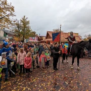 Aper_Markt_Ritter.jpg Ein Ritter reitet in historischer Kleidung, umgeben von feiernden Menschen.