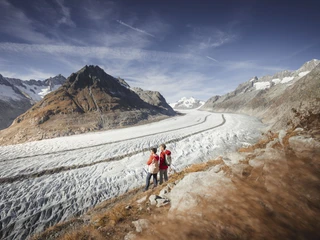 Wanderung entlang des Aletschgletschers Herbstsonne Aletsch Arena mit Wanderpaar auf Pfad entlang des Aletschgletschers im SpätherbstAutumn sun Aletsch Arena with hiking couple on a path along the Aletsch Glacier in late fallSoleil d'automne Aletsch Arena avec un couple de randonneurs sur un sentier le long du glacier d'Aletsch à la fin de l'automne