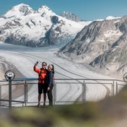 Selfie mit Aussicht am View Point Eggishorn Das View Point Package Aletsch zeigt ein Paar beim Selfie auf dem Eggishorn mit spektakulärer Aussicht auf den Grossen Aletschgletscher