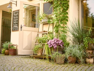 Das KAFF, Mülheim an der Ruhr Charmanter Eingang eines Cafés mit bunten Pflanzen und Kletterpflanzen am Türrahmen.
