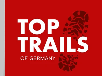 Logo der Top Trails of Germany Logo der Top Trails of Germany mit Fußabdruck auf rotem Hintergrund, weiße Schrift.