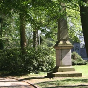 Kriegerdenkmal des deutsch-französischen Krieges 1870/71 Steinernes Kriegerdenkmal von Bäumen umgeben, gedenkt an Konflikt von 1870/71; grüne Parkumgebung.