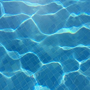 Schwimmbecken Klares, blaues Wasser eines Schwimmbeckens mit sanften Lichtreflexionen auf gefliester Oberfläche.
