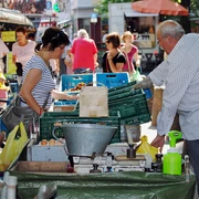 Farmers’ market in Deutz Marktszene mit Menschen, die frisches Obst und Gemüse an einem Kölner Stand begutachten und einkaufen.Market scene with people inspecting and buying fresh fruit and vegetables at a stall in Cologne.