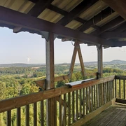 Auf dem Hungebergturm Holzverkleideter Aussichtsturm mit Blick auf bewaldete Hügel und langgezogene, sanfte Täler.