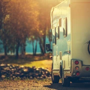 Autumn RV Camping. Modern Camper Van During Late Sunny Fall Afternoon. Scenic RV Park.