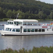 SchiederSee mit Schifffahrt Weißes Ausflugsschiff mit Passagieren gleitet auf einem See, umgeben von grünen Wäldern und sanften Hügeln.